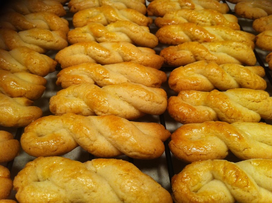 Koulouria, braided shortbread cookies baked golden brown on a cooling rack